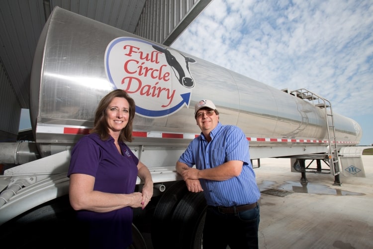 dairy farmer greg watts stands in front of milking truck